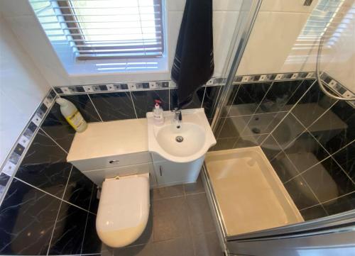 a small bathroom with a sink and a toilet at Self contained Coventry in Coventry
