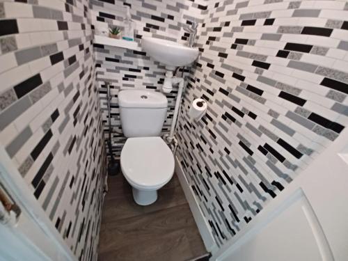 a bathroom with a white toilet and a sink at The Moonflower in Grays Thurrock