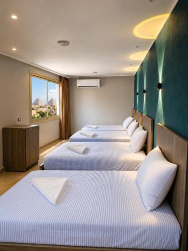 a row of beds in a hotel room at Red Pyramids Hotel in Cairo