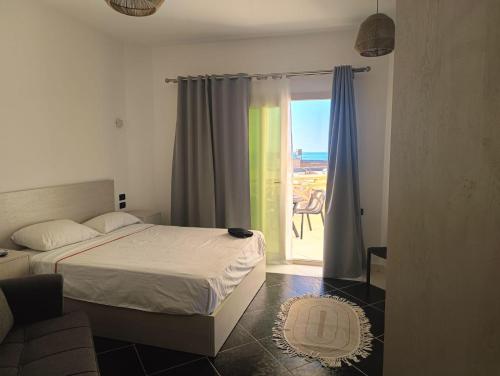 a bedroom with a bed and a view of the ocean at Royal Beach Resort in Hurghada