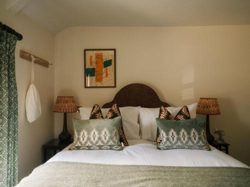 a bedroom with a bed with pillows on it at The Great Decoy in Hurstbourne Tarrant