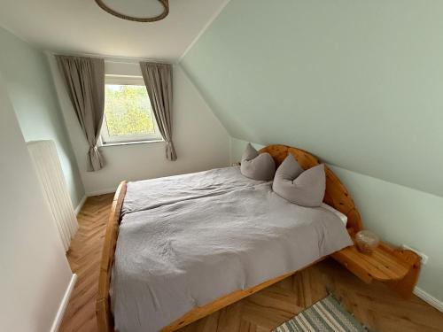 a bedroom with a bed with two pillows on it at Wiesenhuus in Sankt Peter-Ording