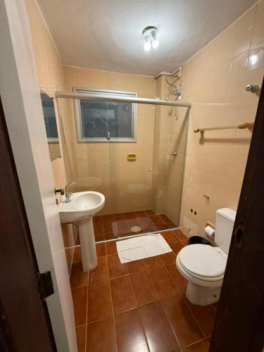 a bathroom with a toilet and a sink at Bravo City Hotel Campinas in Campinas