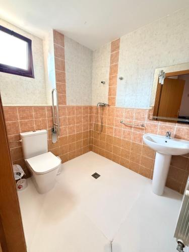 a bathroom with a toilet and a sink at Hostal Restaurante Portell in Portell de Morella