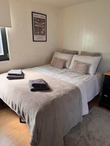 a bedroom with two beds with towels on them at The Snug in Yeovil