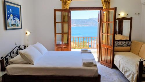 una camera da letto con un letto e vista sull'oceano di Olympos Studios ad Amoopi