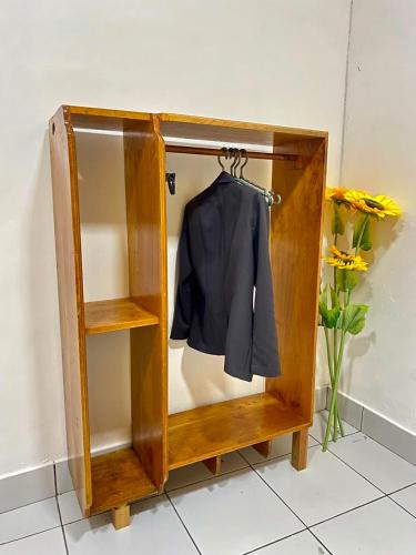 a wooden cabinet with a jacket hanging in it at Estadia colonial in Suchitoto