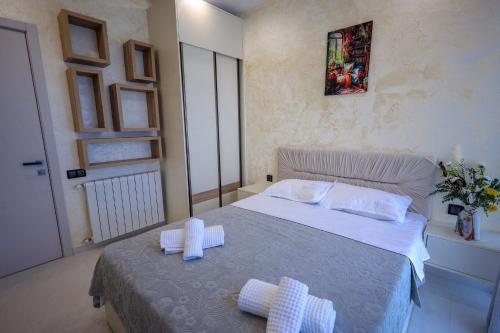 a bedroom with a bed with two towels on it at Modern Mountain Villa with Pool near Tbilisi in Bulach'auri