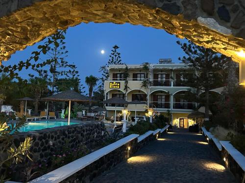 a view of a hotel from an archway at Santa Elena in Kamari