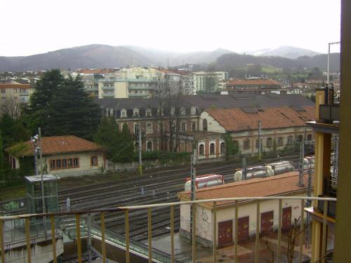 a view of a train station with trains on the tracks at Pensión Gema in Irún