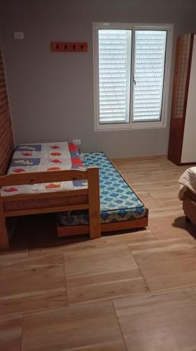 a bedroom with a bed and a wooden floor at MALU casa quinta in Rafaela