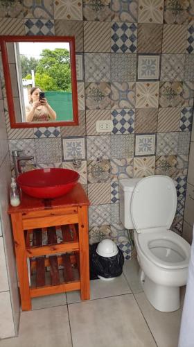 a bathroom with a sink and a toilet and a mirror at MALU casa quinta in Rafaela