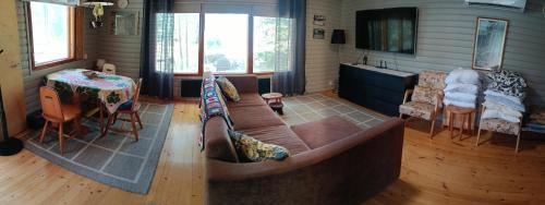 a living room with a couch and a table at Ahlaistentupa in Pori