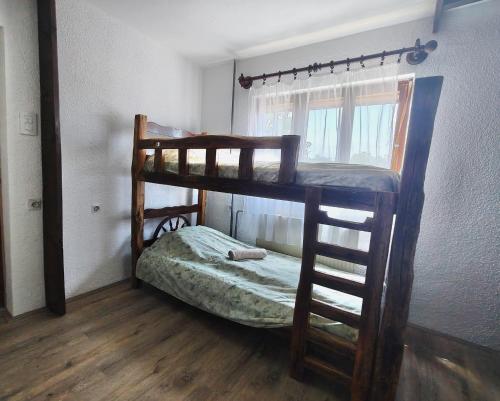 two bunk beds in a room with a window at Čardak seosko domaćinstvo 
