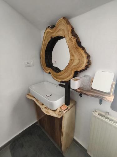 a bathroom with a wooden mirror and a sink at Čardak seosko domaćinstvo 