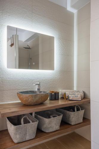 a bathroom with a sink and a mirror at Cretan View - Valley & Mountains View Sitia in Áyios Yeóryios