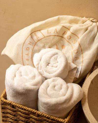 a basket filled with white towels on a table at La Posada Hotel Boutique in Manzanillo