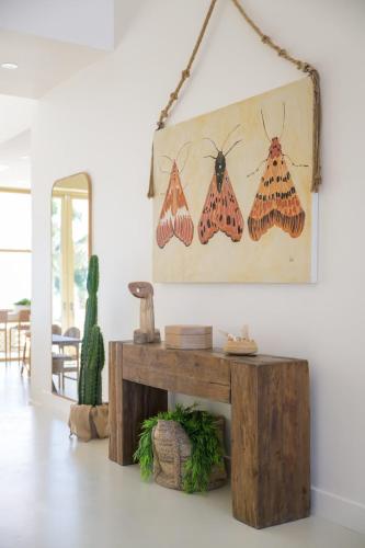 a living room with butterflies hanging on the wall at Kailoa Villa in Long Bay Hills