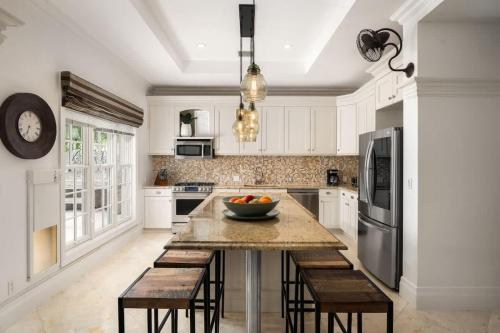 a kitchen with a table with a bowl of fruit on it at Abundance and Prosperity Villa in Long Bay Hills