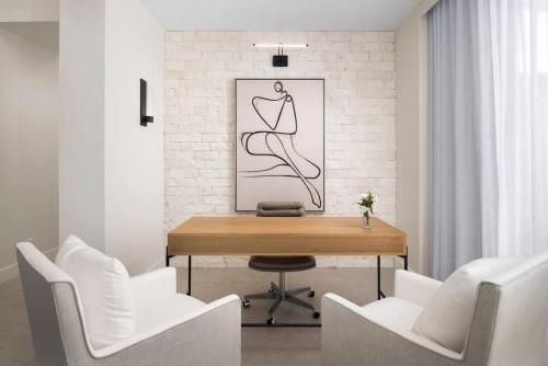 a dining room with a wooden table and white chairs at Upper East Side Enclave # 18 in Leeward