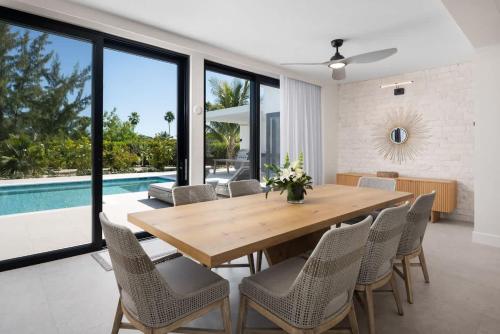 a dining room with a wooden table and chairs and a pool at Upper East Side Enclave # 18 in Leeward