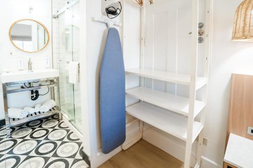 a bathroom with white shelves and a blue tie at The Belmont Shore Inn in Long Beach
