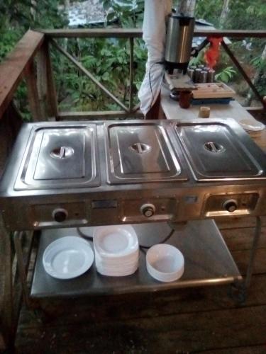 a stove with two sinks and plates on a table at Miranda in Arroyo Chico Arriba