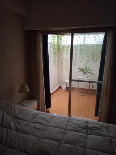 a bedroom with a bed and a view of a room at Arco Iris in Miramar