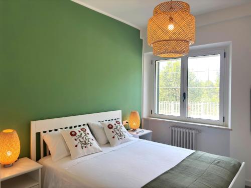 a bedroom with a white bed and a window at Villa Mario in Senigallia