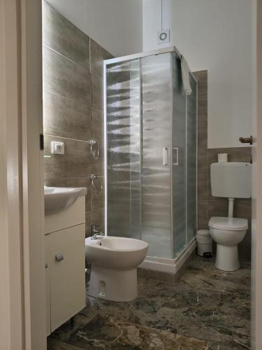 a bathroom with a toilet and a sink and a shower at Domus Cesena in Cesena