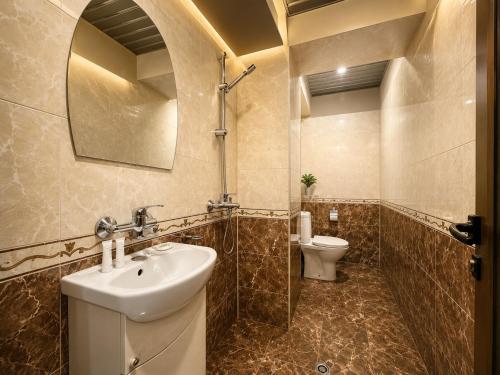 a bathroom with a sink and a toilet at Hotel Maria in Vratsa