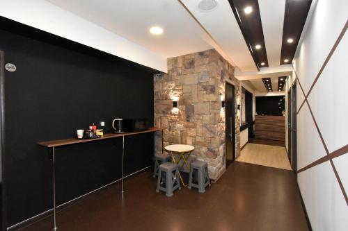 a bar in a room with a stone wall at Dur baca guest house in Yerevan