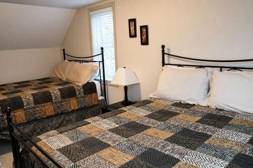 a bedroom with two beds and a lamp at JACKSON HOLE HIDEAWAY in Jackson