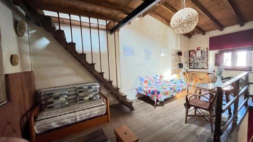 a living room with a staircase and a couch at Casa Medieval de Nisa in Nisa