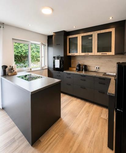 a kitchen with a large island in the middle at Harmony Hideaways I 90qm I Bergblick I 3 Balkone I seenah in Prien am Chiemsee