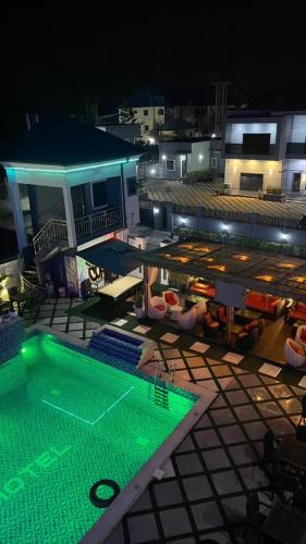 a view of a swimming pool at night at Pretelia Hotel in Warri