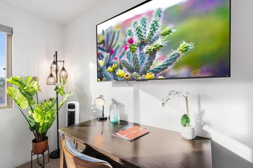 a desk in a room with a painting on the wall at Sunny & Bright Charm with Community Pool in Tucson