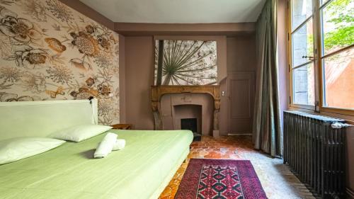 a bedroom with a bed and a fireplace at Authentic Flat in Dijon in Dijon