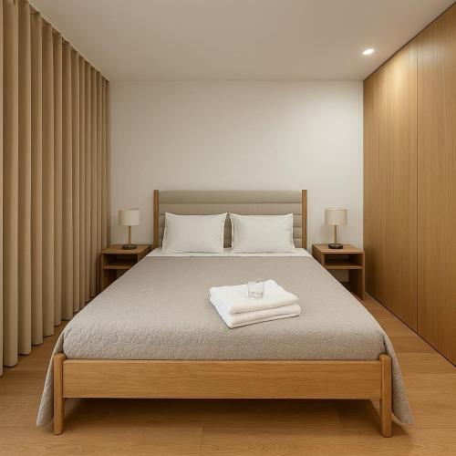 a bedroom with a large bed with two night stands at Quinta de Santa Ana, em Vizela in Infias