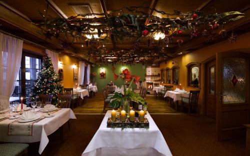 a dining room with tables and a christmas tree at Alpejski Boutique Hotel in Karpacz