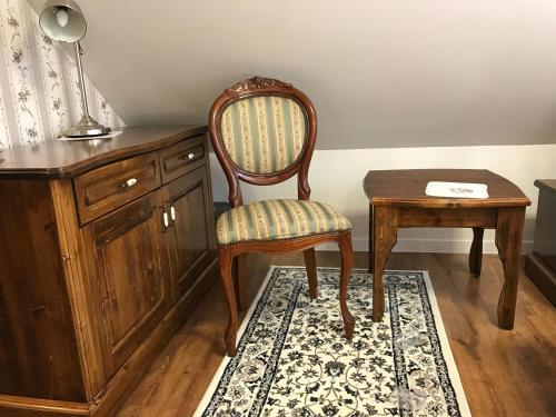 a chair and a table in a room with a desk at CenterCity Apartments in Prešov