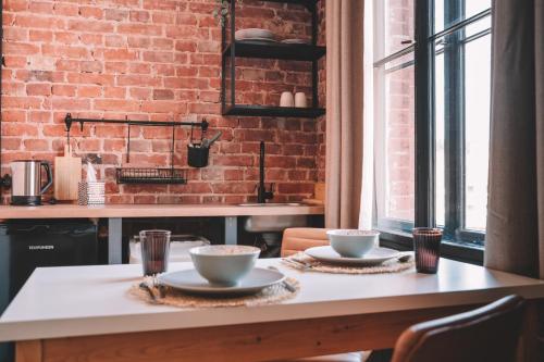 a kitchen with a table with two cups on it at Old Post Loft Apartments in Spremberg