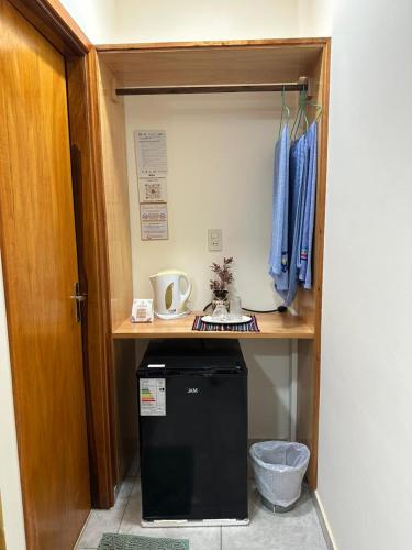 a small refrigerator under a desk in a room at Vivíana Hause Hospedaje in Cambyretá
