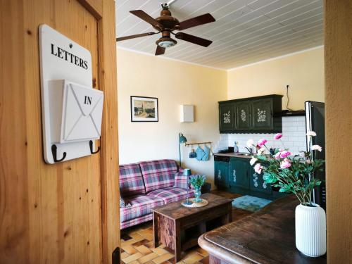 a living room with a couch and a table at Ferienwohnung Dreamy Daisy in Morbach