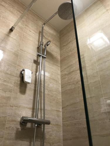 a shower with a glass door in a bathroom at CenterCity Apartments in Prešov
