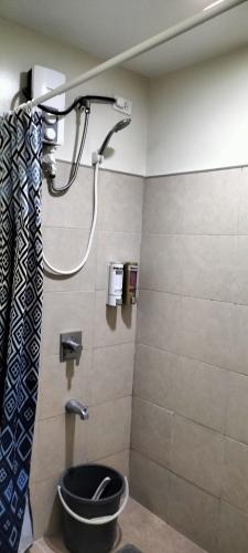 a bathroom with a shower and a toilet in it at Cozy33 The Persimmon Studio, Near Airport, SM, Ayala, Cebu Business Park, Cebu IT Park in Cebu City