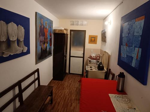 a living room with a red couch and a refrigerator at Artistic Mini Loft & Sun Terrace in La Paz