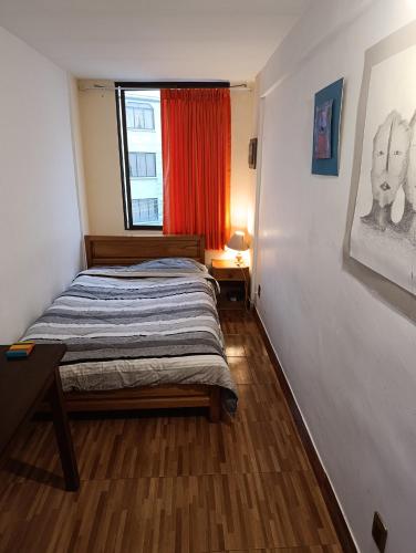 a small bedroom with a bed and a window at Artistic Mini Loft & Sun Terrace in La Paz