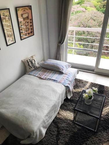 a bedroom with a bed and a glass table at Palermo facing Las Heras Park in Buenos Aires