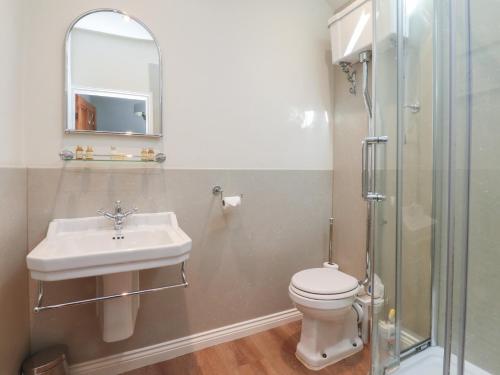 a bathroom with a sink and a toilet and a shower at Chamber End Fold in Skipton
